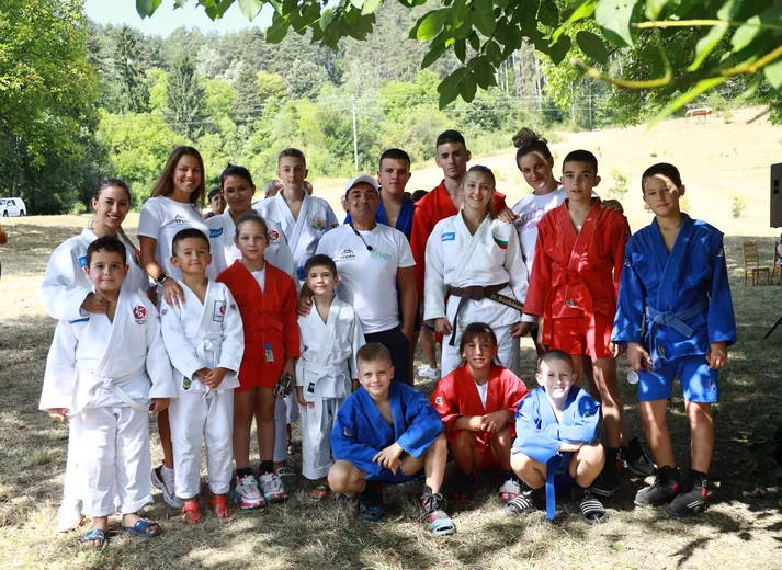Children in judo and sambo kimonos, a group photo after the session