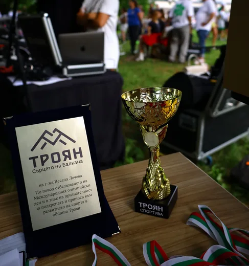 The festival cup and plaque, with the medals beside them