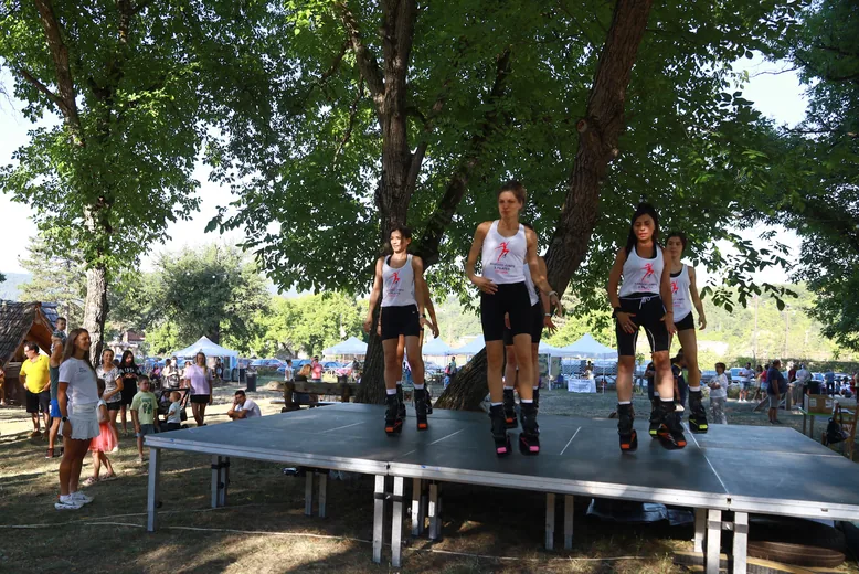 A dance troupe on the stage in the meadow